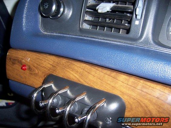 100_1715.jpg not centered in the middle of plastic-tree-sourced-wood trim, the metal parts behind it prevent it, plus it wouldn't be as steadily attached if it were.