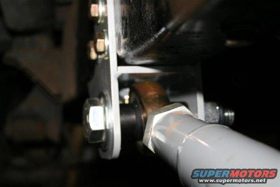 Close-up of a suspension component with bolts and a metal bracket