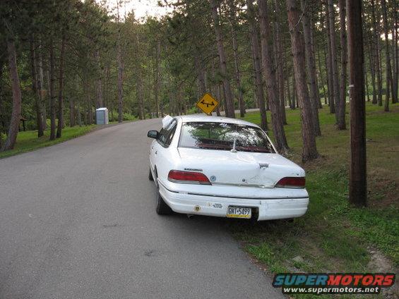 1992 Ford Crown Victoria rear view, white sedan on roadside