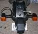 2002 Kawasaki Ninja - This is a close-up of a motorcycle's rear section, including turn signals and a license plate, lying on a carpeted surface.