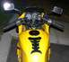 2002 Kawasaki Ninja - Close-up view of a yellow motorcycle's handlebars, dashboard, and fuel tank.