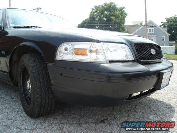 Black 2000 Ford Crown Victoria front end with a honeycomb grille and clear headlights