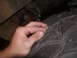 1991 Ford Bronco - A hand holds a coin to the tire tread, likely to show tread depth.
