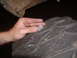 1991 Ford Bronco - A hand is shown holding a coin on the deep tread of a large tire.