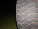 1991 Ford Bronco - A tire tread is visible with a small green leaf stuck in the pattern.