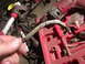 1991 Ford Bronco - A close-up shows a worn wire harness, likely needing replacement, amidst various tools.