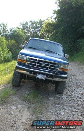Blue Ford F-Series truck on a dirt road. License plate reads 531-VW1