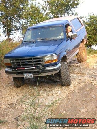 1996 Ford Bronco on a rocky trail, driver visible through the window