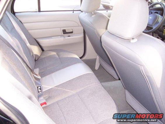 Interior of a 2003 Ford Crown Victoria showing gray cloth seats and door panel