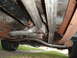 1990 Ford Ranger - Underside view of a vehicle's exhaust system, driveshaft, and transmission components.