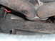 1990 Ford Ranger - Close-up view of rusted exhaust manifold pipes and undercarriage components.