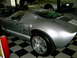 1966 Ford GT - A silver 1966 Ford GT is parked in a garage next to another similar vehicle.
