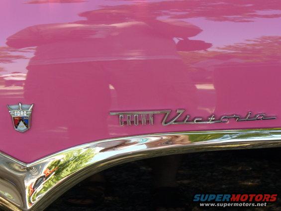 Pink 1956 Ford Crown Victoria fender with chrome trim and badge