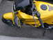 2002 Kawasaki Ninja - A yellow Kawasaki motorcycle is parked on asphalt, with its front fairing, mirror, and handlebars visible.