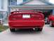 1994 Ford Probe - Rear view of a red car, identified as a Probe, with a spoiler and dual exhaust pipes.