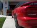 1994 Ford Probe - A red coupe with a spoiler is parked in front of a garage, showing the rear badging.