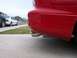1994 Ford Probe - Rear view of a red car showing its bumper and exhaust pipes, with other vehicles and houses in the background.