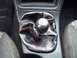 1994 Ford Probe - Close-up of a car's interior gear shifter with a carbon fiber knob and red stitching on the boot.