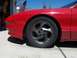 1994 Ford Probe - Close-up of the front wheel and fender of a red 1994 Ford Probe.