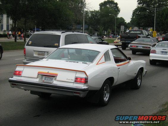 White coupe with orange and yellow stripes on the rear, 'CAN AM' badging
