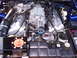 2003 Ford Mustang - The engine bay of a 2003 Ford Mustang features a prominent supercharger and blue accents.