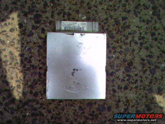 Ford electronic control unit with a smaller Ford module on top, resting on a textured surface