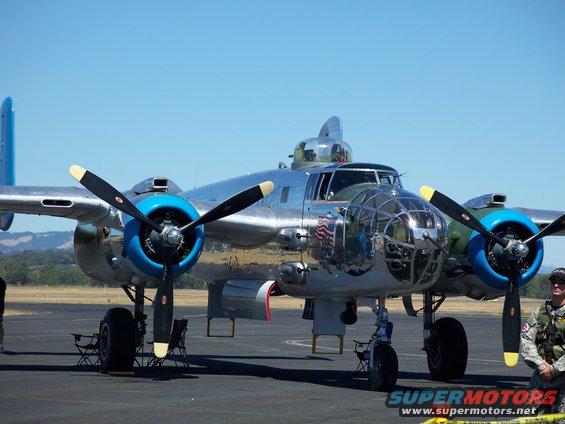 North American B-25 Mitchell bomber parked on tarmac, clear blue sky