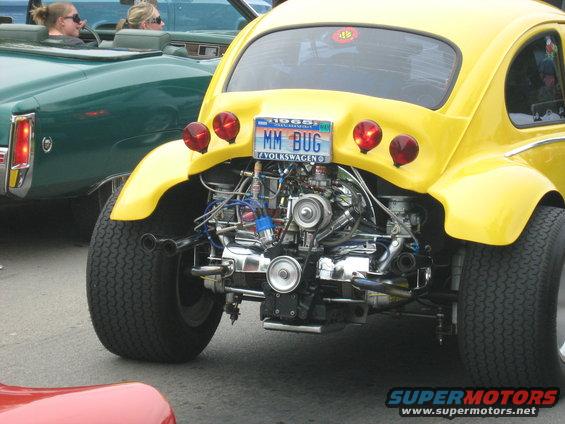 Yellow Volkswagen Beetle with exposed engine and 1968 license plate