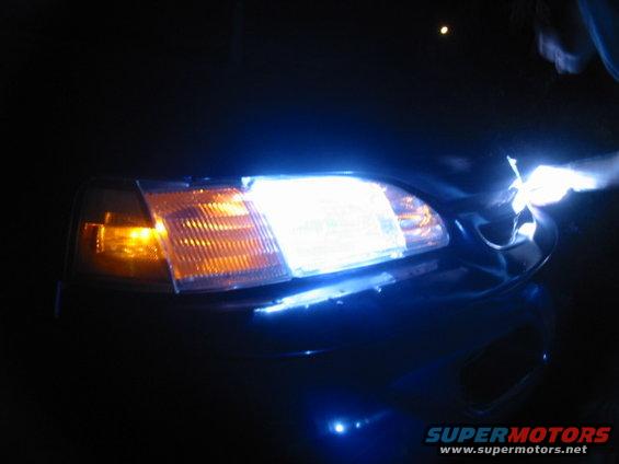 1995 Ford Thunderbird headlight with bright white and amber turn signal lights illuminated