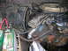1978 Ford F-250 - Close-up view of a V8 engine bay, showing the carburetor, distributor, and battery.