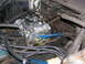 1978 Ford F-250 - Close-up view of a vehicle's engine bay, focusing on the carburetor and associated components.