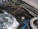 1978 Ford F-250 - A close-up view of a vehicle's engine compartment, focusing on the carburetor and surrounding components.