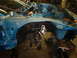 1993 Ford Probe - The front section of a disassembled blue car is visible, with suspension components exposed.