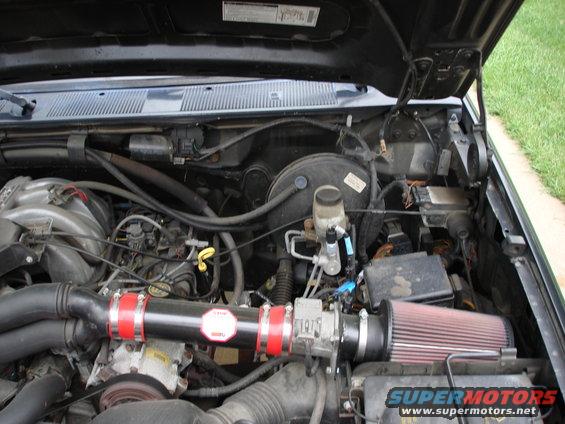 Engine bay with aftermarket air intake and red filter