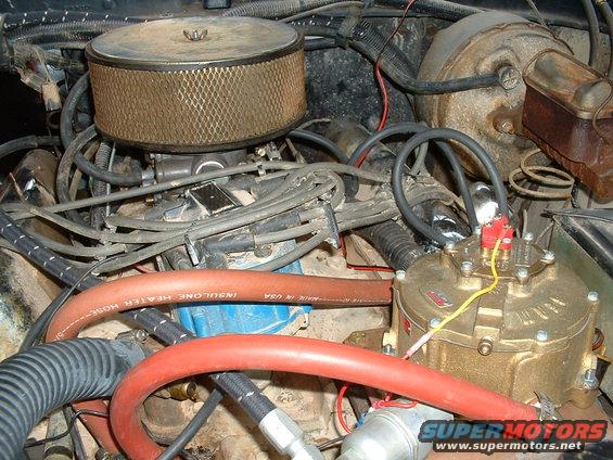 Engine bay with air filter, hoses, and brass regulator