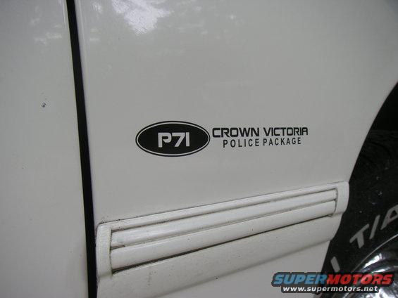 Side view of a white vehicle door with a P71 Crown Victoria Police Package decal