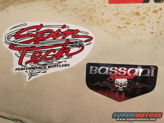 Spin Tech Performance Mufflers and Bassani Xhaust stickers on a light-colored surface