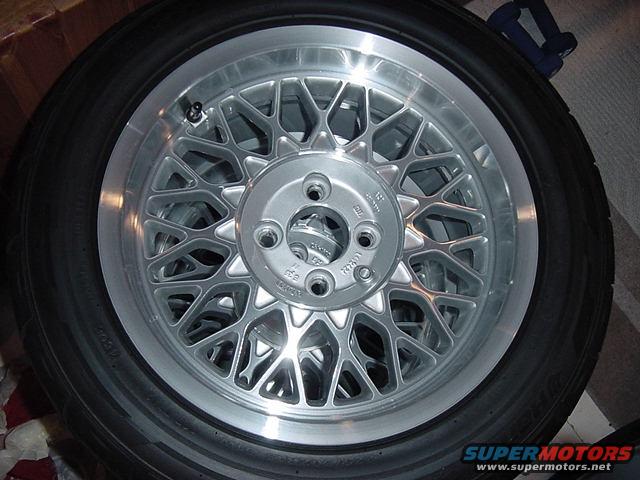BMW alloy wheel with tire, showing intricate spoke design and tire sidewall