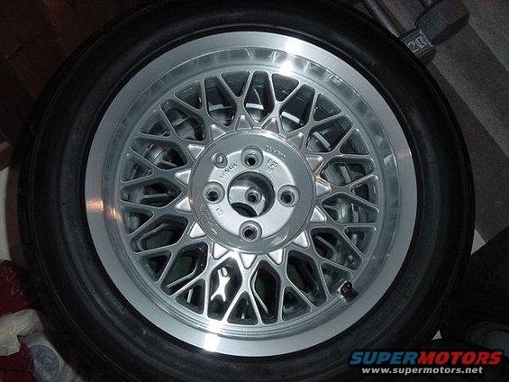 Close-up of a silver mesh wheel with a tire