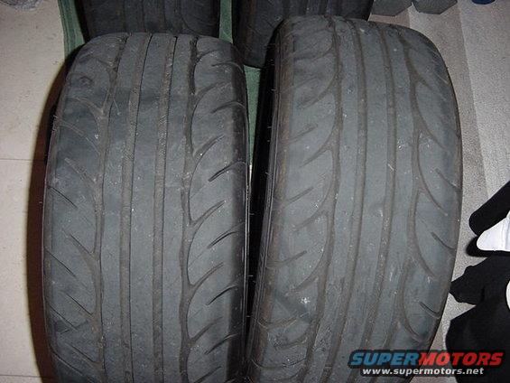 Two used performance tires, close-up view