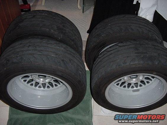 four tires stacked on custom wheels