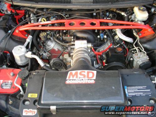 Engine bay with red strut bar and MSD Super Conductor air intake