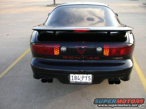 Rear of a black 2002 Pontiac Trans Am with a spoiler and dual exhaust pipes