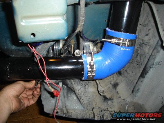 Blue silicone turbo hose with metal clamps and red wires connected to black pipe