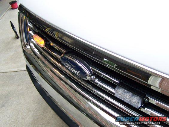 Close-up of 2003 Ford Crown Victoria grille with Ford emblem and added emergency lights