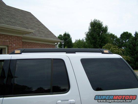 White SUV side view with roof rack lights