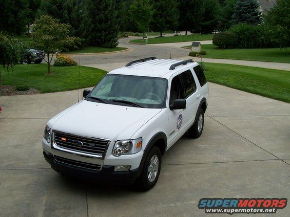 White Ford Explorer parked on driveway, another SUV in background
