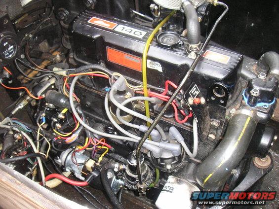 Boat engine with "140" visible on the valve cover, complex wiring, and a SuperMotors.net watermark
