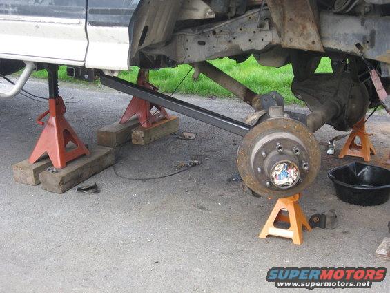 1990 Ford F-250 underbody with suspension removed, on jack stands