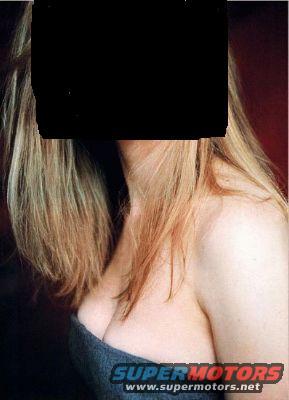 woman with blonde hair, wearing a denim top, with a black box covering her face. Supermotors.net logo at bottom